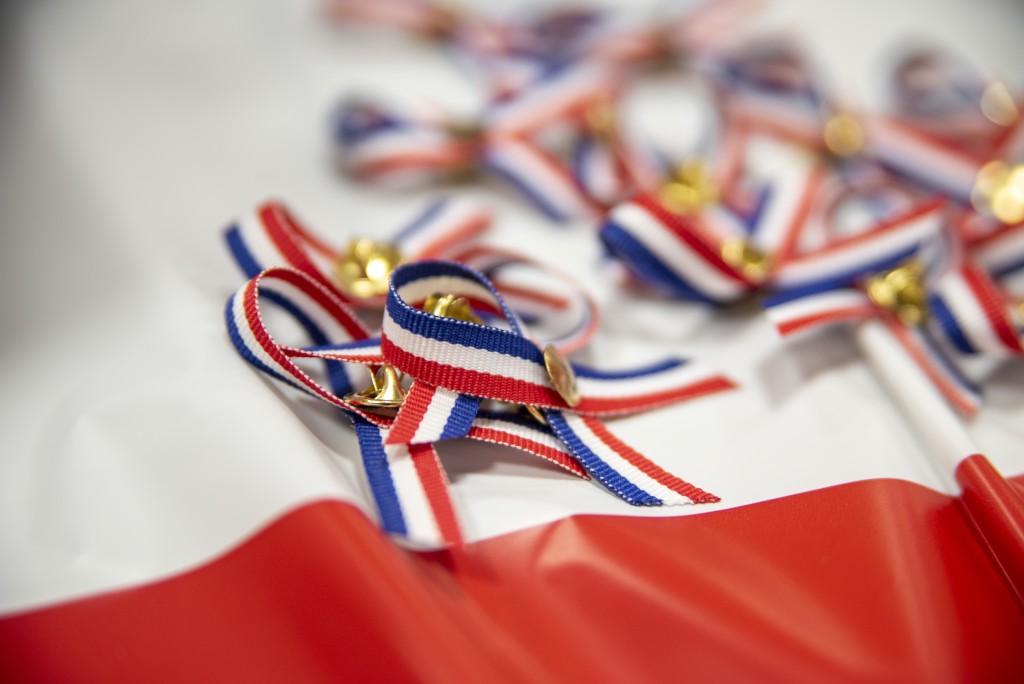 Red, white, and blue ribbons are laid out on a table