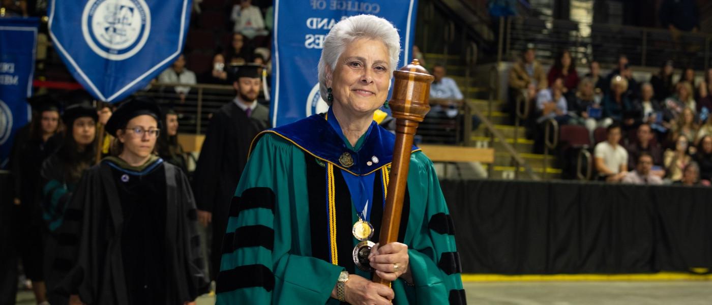Prof. Marilyn Guggliuci bears the University mace